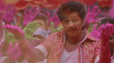 A Man Is Surrounded By Pink And Green Hands GIF