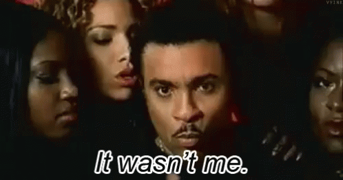 A Man Is Surrounded By Women And Says `` It Wasn 'T Me . '' GIF