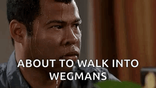 A Man Is Sweating And Looking At The Camera With The Words `` About To Walk Into Wegmans '' Written Above Him . GIF