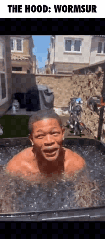 A Man Is Swimming In A Tub Of Water With The Caption " The Hood Wormsur " GIF