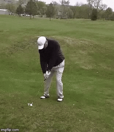 A Man Is Swinging A Golf Club On A Golf Course While Dancing . GIF