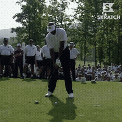 A Man Is Swinging A Golf Club On A Golf Course With A Skratch Logo Behind Him GIF