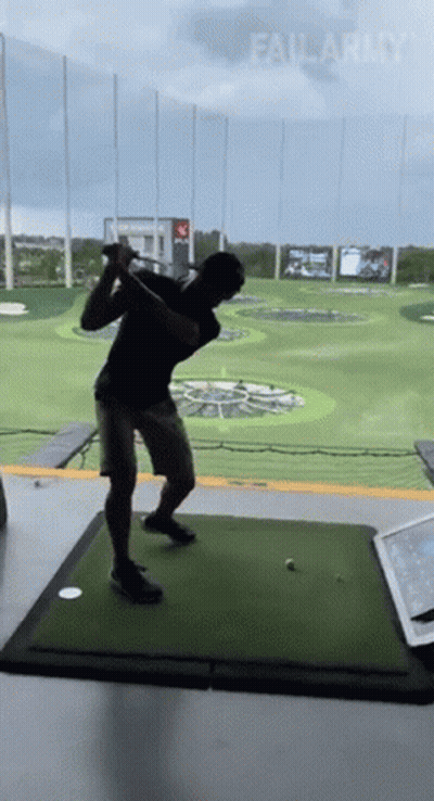 A Man Is Swinging A Golf Club On A Golf Course With Failarmy Written On The Bottom GIF
