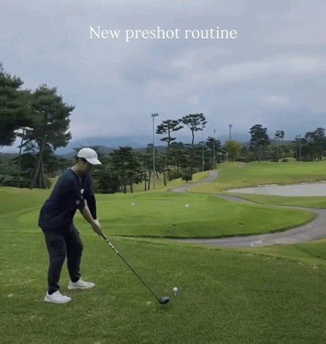 A Man Is Swinging A Golf Club On A Golf Course With The Words " New Preshot Routine " Above Him GIF