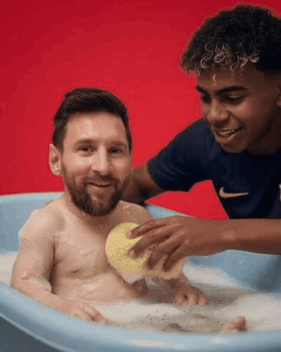 A Man Is Taking A Bath With A Sponge While Another Man Watches GIF