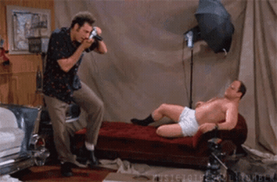A Man Is Taking A Picture Of Another Man In Underwear GIF