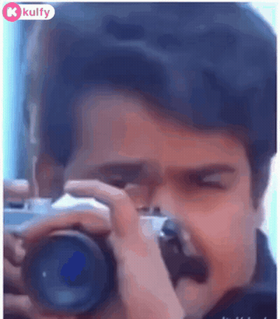 A Man Is Taking A Picture Of Himself With A Camera . GIF