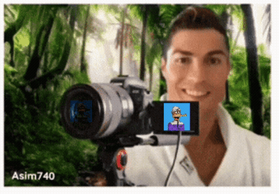 A Man Is Taking A Picture Of Himself With A Camera With A Picture Of A Cartoon Character On The Screen GIF