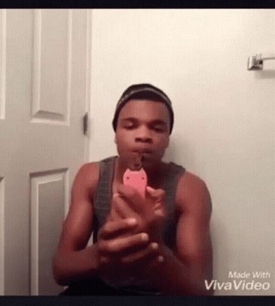A Man Is Taking A Picture Of Himself With A Cell Phone . GIF
