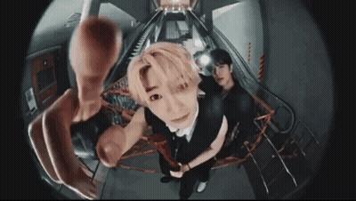 A Man Is Taking A Picture Of Himself With A Fisheye Lens While Another Man Looks On . GIF
