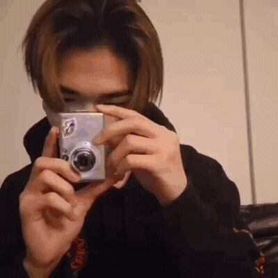 A Man Is Taking A Picture With A Camera . GIF