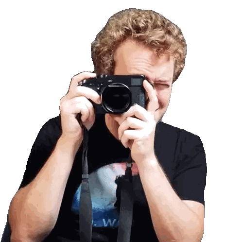 A Man Is Taking A Picture With A Camera With A Strap That Says ' W ' On It Sticker