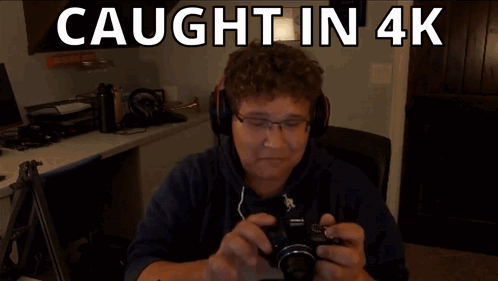 A Man Is Taking A Picture With The Words Caught In 4K Behind Him GIF