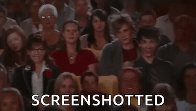 A Man Is Taking A Screenshot Of A Crowd Of People In A Theatre . GIF