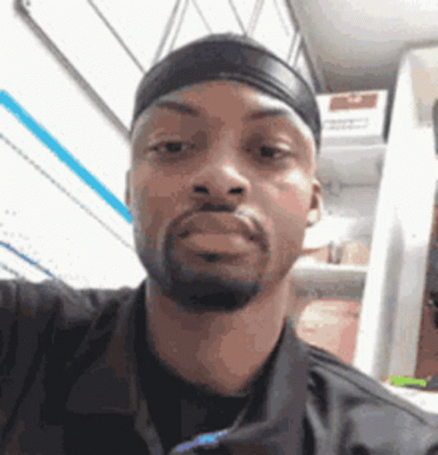 A Man Is Taking A Selfie In Front Of A Refrigerator . GIF