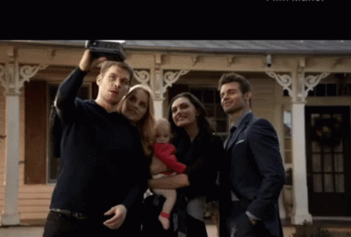 A Man Is Taking A Selfie With His Family GIF