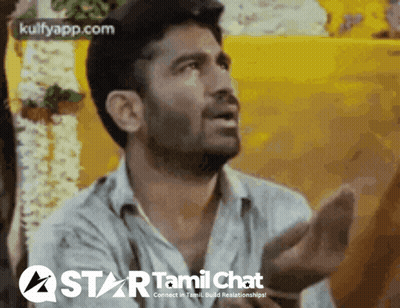 A Man Is Talking In Front Of A Yellow Wall With The Words Star Tamil Chat On The Bottom GIF