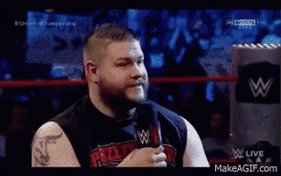 A Man Is Talking Into A Microphone In A Wrestling Ring GIF