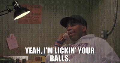 a man is talking on a cell phone and saying `` yeah , i 'm licking your balls ''