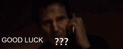 A Man Is Talking On A Cell Phone And The Words `` Good Luck '' Are Visible Behind Him . GIF