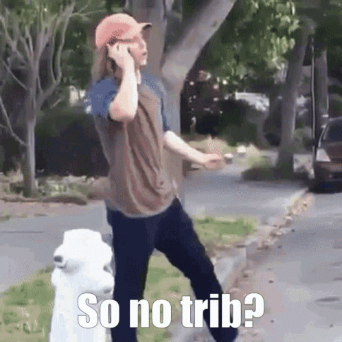 A Man Is Talking On A Cell Phone Next To A White Dog . GIF