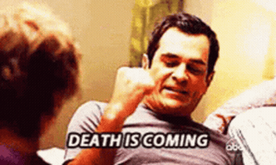 a man is talking on a cell phone while a woman looks on and says death is coming .