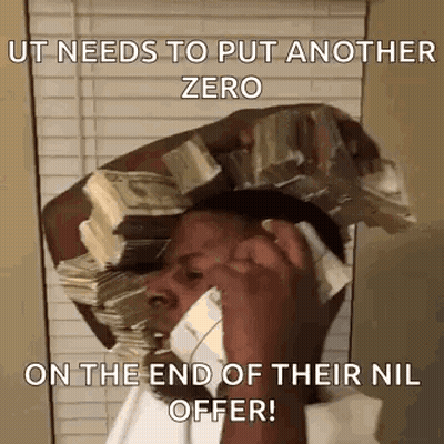 A Man Is Talking On A Cell Phone While Holding A Pile Of Money On His Head . GIF