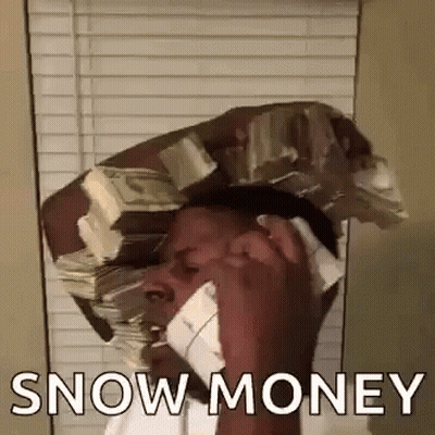 A Man Is Talking On A Cell Phone While Holding A Stack Of Money On His Head . GIF