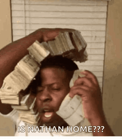 A Man Is Talking On A Cell Phone While Holding A Stack Of Money On Top Of His Head . GIF