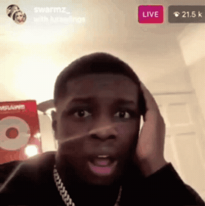 A Man Is Talking On A Cell Phone While Sitting In A Room . GIF