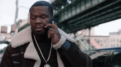 A Man Is Talking On A Cell Phone While Wearing A Fur Coat . GIF