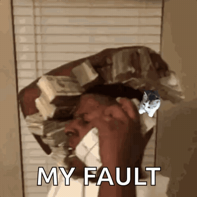 A Man Is Talking On A Cell Phone With A Cat On His Head . GIF