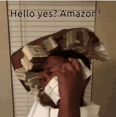 A Man Is Talking On A Cell Phone With A Stack Of Money On His Head GIF