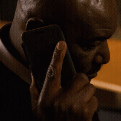 A Man Is Talking On A Cell Phone With His Left Hand GIF
