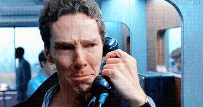A Man Is Talking On A Pay Phone And Making A Sad Face GIF