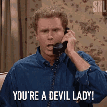 A Man Is Talking On A Phone And Saying You 'Re A Devil Lady GIF
