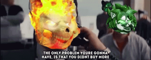 A Man Is Talking On A Phone Next To A Burning Skull And A Green Monster . GIF