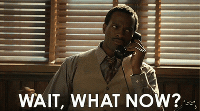 A Man Is Talking On A Phone With The Words Wait What Now Written Below Him GIF