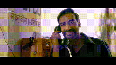 A Man Is Talking On A Yellow Pay Phone GIF
