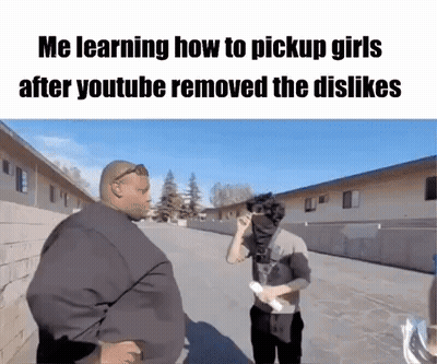 A Man Is Talking To Another Man In A Parking Lot While Holding A Piece Of Paper . GIF