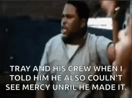 A Man Is Talking To Another Man In A Prison Cell While Holding A Microphone . GIF
