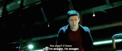 A Man Is Talking To Another Man In A Room With A Large Window . GIF