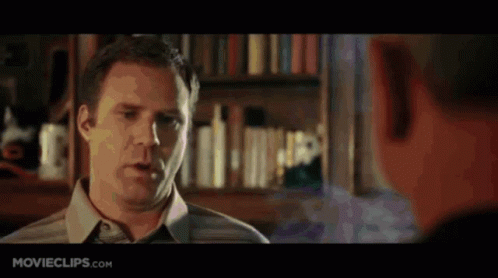 A Man Is Talking To Another Man In Front Of A Bookshelf With Movieclips.com Written On The Bottom Of The Screen GIF