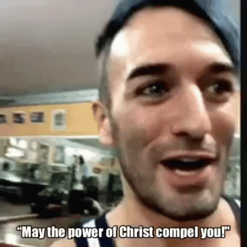 A Man Is Talking To Someone In A Gym And Saying `` May The Power Of Christ Comel You ! '' GIF