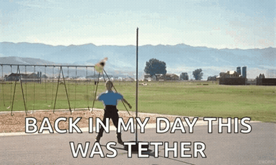 A Man Is Throwing A Frisbee In A Field With The Words " Back In My Day This Was Tether " On The Bottom GIF