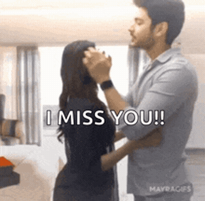 A Man Is Touching A Woman 'S Face And Saying `` I Miss You ! '' GIF
