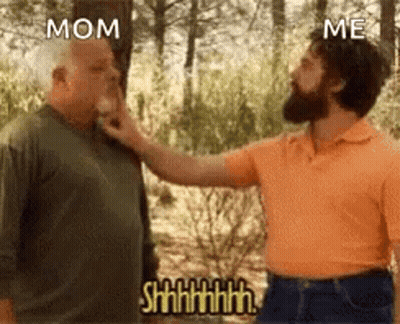 A Man Is Touching Another Man 'S Face In The Woods . GIF