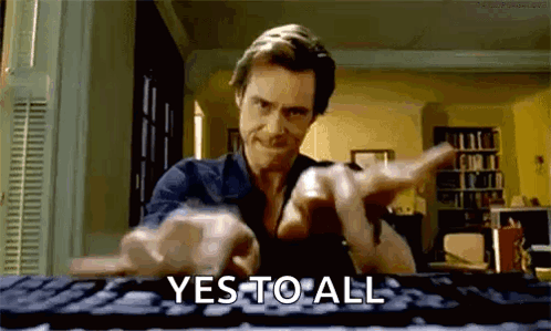 A Man Is Typing On A Keyboard And Pointing At The Camera While Saying Yes To All . GIF