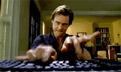 A Man Is Typing On A Keyboard While Making A Funny Face GIF