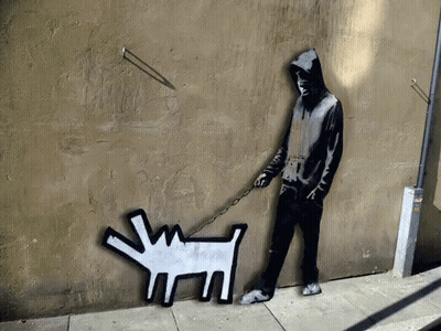 A Man Is Walking A Dog On A Leash GIF
